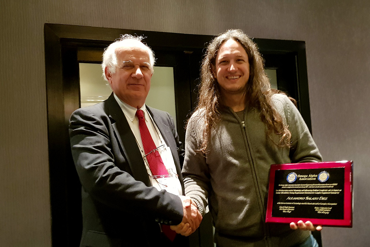 Dr. Alejandro Salado (right) receives the award plaque from Dr. Cihan Dagli, Professor and Founder and Director of the Systems Engineering Graduate Program at Missouri University of Science and Technology. Dr. Alejandro Salado (right) receives the award plaque from Dr. Cihan Dagli, Professor and Founder and Director of the Systems Engineering Graduate Program at Missouri University of Science and Technology.