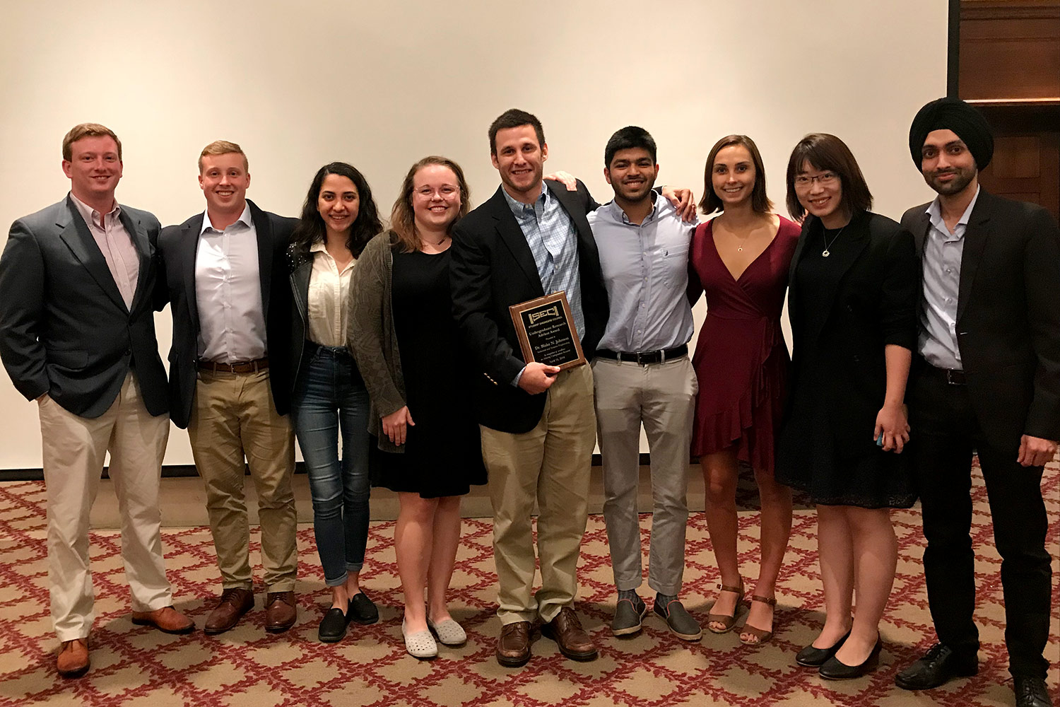 Dr. Blake Johnson with students and the Student Engineers council (SEC) Undergraduate Research Advisor Award (from left) David McIlvain, Alex Haring, Ezgi Kucukdeger, Ellen Cesewski, Dr. Blake Johnson, Sahil Laheri, Elena Karakozoff, Yuxin (Janelle) Tong, and Manjot Singh