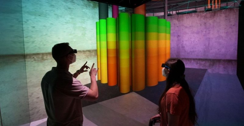 two students wear Virtual reality goggles to vizualize radiation