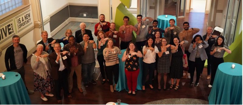 group of alumni pose during an alumni event in blacksburg